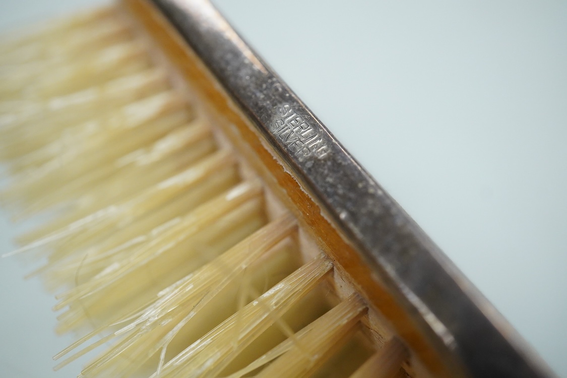An Elizabeth II engine turned silver Art Deco style four pieced dressing table mirror, brush and comb set, W.I. Broadway & Co, Birmingham, 1961/63/65, mirror 27.8cm.